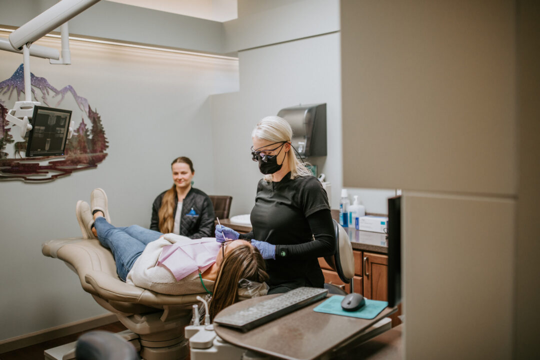 A photo of a dental patient being treated in a dentist room
