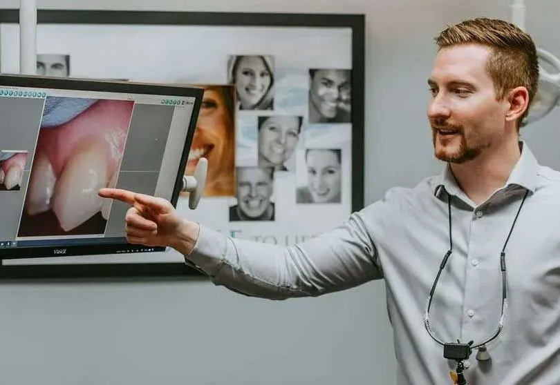 A close up of a person in a dental chair receiving dental treatment