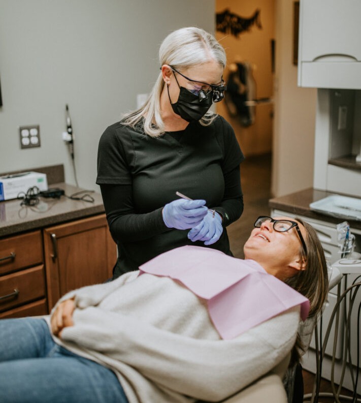 A photo of a dental patient being treated in a dentist room